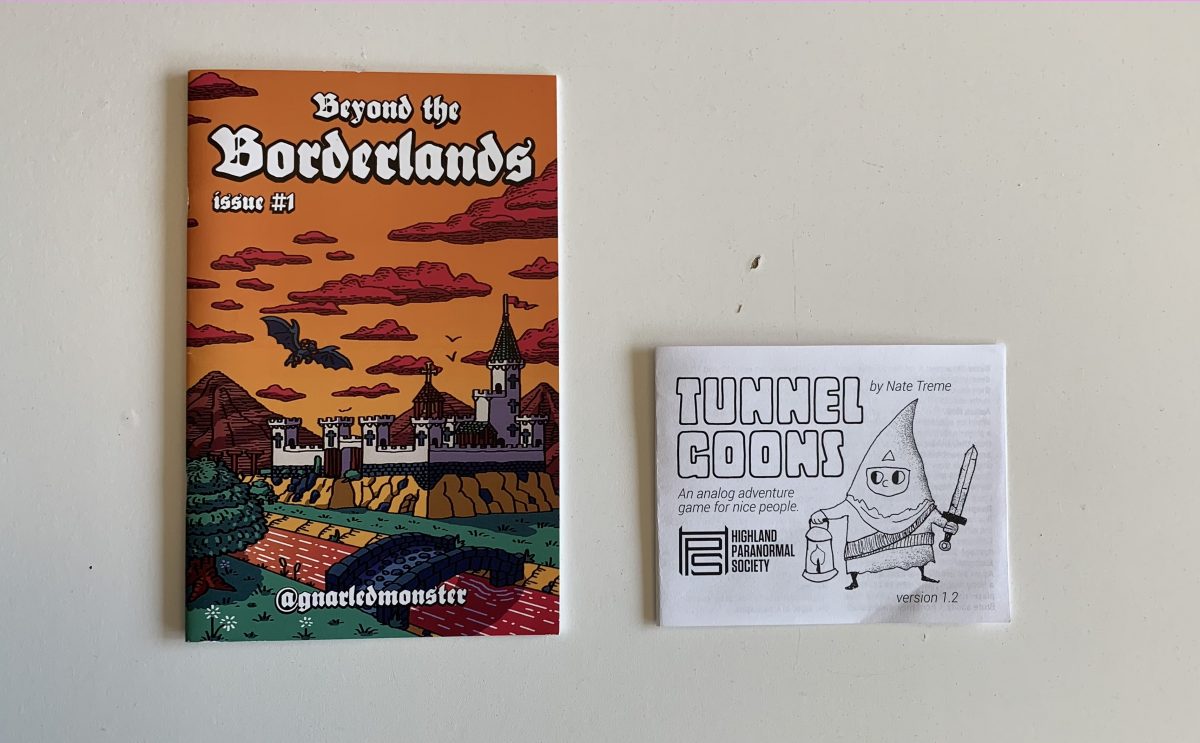 Staplebound, half-letter Beyond the Borderlands zine. Cover Depicts a castle in the wilderness at sunset with winged rams flying above. And Tunnel Goons rule printout. Cover depicts a cute fantasy adventure carrying a lantern and a sword.